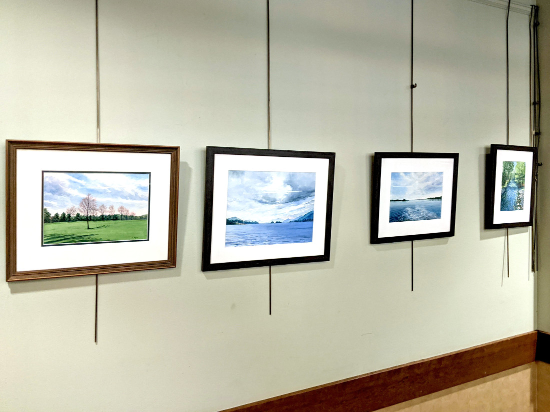 Brilliantly colored, scenic photographs adorn a wall.