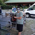 Thumbnail: boy with skeleton painted face petting brown miniature horse outside